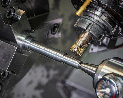 Close-up of precision CNC-machined carbon steel fitting threads showing uniform crests and clean chamfers.